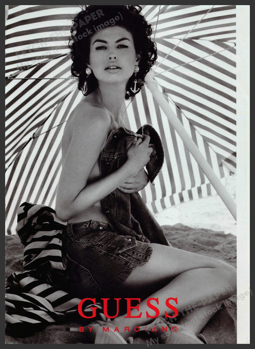 Guess by Marciano 2000s Print Advertisement 2007 Bare Beach umbrella Sand Legs Fetch-the-Paper